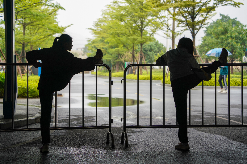 2023年3月31日，成年人电影第十六届运动会竞技体育组田径比赛在清远体育中心田径场开赛，运动员比赛前在休息区域做拉伸运动。清远日报记者 邱炜民 摄.jpg